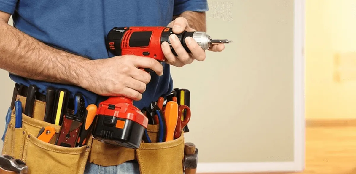 Handyman holding a power drill for home repairs and installations in Honolulu, HI