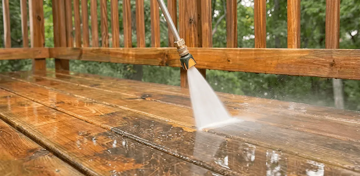 Pressure washing a wood deck to remove dirt and buildup in Honolulu, HI
